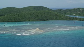 AX102_140 - 4.8K aerial stock footage of Sailboats in turquoise waters along a tree covered coast, Culebra, Puerto Rico 
