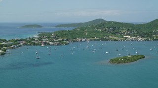 AX102_142 - 4.8K aerial stock footage of Sail boats in sapphire blue water near a coastal town, Culebra, Puerto Rico 