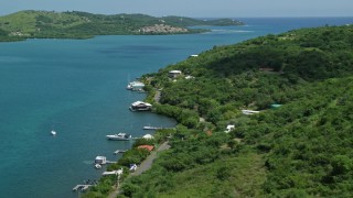 AX102_153 - 4.8K aerial stock footage of Lush vegetation along the coast and sapphire waters, Culebra, Puerto Rico 