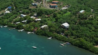 AX102_155E - 4.8K aerial stock footage of oceanfront homes overlooking sapphire waters, Culebra, Puerto Rico