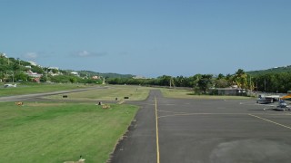 AX102_166 - 4.8K aerial stock footage of a Take off from Benjamín Rivera Noriega Airport over sapphire blue waters, Culebra 
