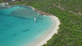 AX102_180 - 4.8K aerial stock footage of Boats in turquoise blue water along a white sand beach, Culebrita, Puerto Rico 
