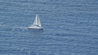 AX102_193E - 4.8K aerial stock footage of a catamaran on sapphire blue waters, Atlantic Ocean
