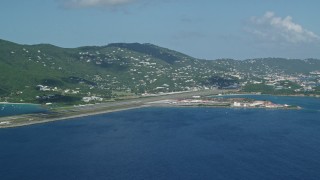 AX102_195 - 4.8K aerial stock footage Approaching Cyril E King Airport and coastal homes, St. Thomas 