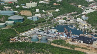 AX102_198 - 4.8K aerial stock footage of a Power plant along the water, Charlotte Amalie, St. Thomas 