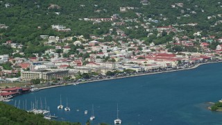 AX102_205 - 4.8K aerial stock footage of Houses in a coastal town along sapphire blue waters, Charlotte Amalie, St. Thomas 