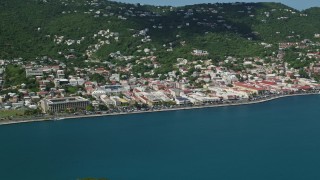 AX102_207E - 4.8K aerial stock footage of a coastal town on a hillside along sapphire waters, Charlotte Amalie, St. Thomas