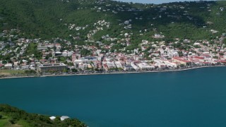 AX102_208 - 4.8K aerial stock footage of a Coastal town on a hillside along sapphire waters, Charlotte Amalie, St. Thomas