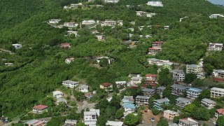AX102_212 - 4.8K aerial stock footage of Upscale hillside homes nestled among trees, Charlotte Amalie, St. Thomas 