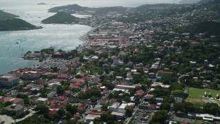 AX102_214E - 4.8K aerial stock footage of a coastal town seen from the hills toward the ocean, Charlotte Amalie, St. Thomas