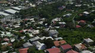 AX102_218 - 4.8K aerial stock footage of Hillside homes among trees, Charlotte Amalie, St Thomas 