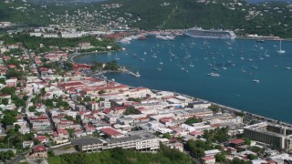 AX102_220 - 4.8K aerial stock footage of a Coastal town and sapphire waters with sailboats, Charlotte Amalie, St Thomas 