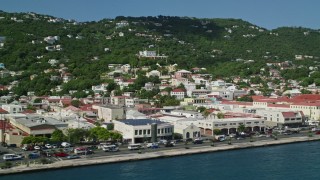 AX102_227E - 4.8K aerial stock footage of coastal buildings and hillside homes, Charlotte Amalie, St Thomas