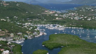 AX102_238 - 4.8K aerial stock footage of a Marina with boats in blue ocean waters, Benner Bay, St Thomas