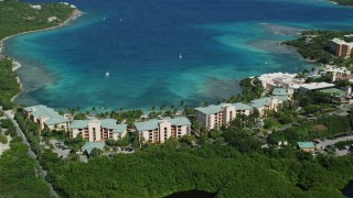 AX102_242E - 4.8K aerial stock footage of The Ritz-Carlton resort by turquoise waters, St Thomas