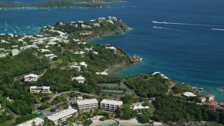 AX102_245E - 4.8K aerial stock footage of Secret Harbor Beach Resort and oceanfront mansions by turquoise Caribbean waters, St Thomas, US Virgin Islands