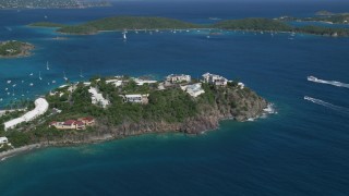 AX102_247 - 4.8K stock footage aerial video of Hillside oceanfront homes on sapphire blue waters, East End, St Thomas 