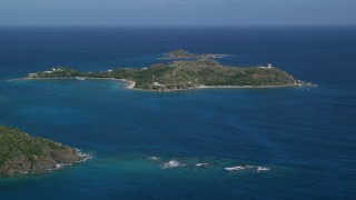 AX102_248 - 4.8K aerial stock footage of Little St James Island surrounded by sapphire waters, St Thomas, US Virgin Islands