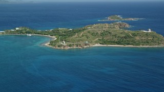 AX102_248E - 4.8K aerial stock footage of Little St James Island surrounded by sapphire waters, St Thomas, US Virgin Islands