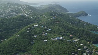 AX102_259 - 4.8K stock footage aerial video of Hilltop homes over looking the blue ocean waters, East End, St Thomas 