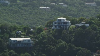 AX102_261 - 4.8K aerial stock footage of a Hilltop home surrounded by trees, East End, St Thomas