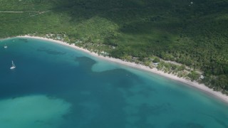AX102_270 - 4.8K aerial stock footage of White sand Caribbean beach along turquoise blue waters, Magens Bay, St Thomas 