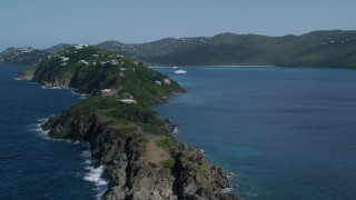 AX102_280 - 4.8K aerial stock footage of Hillside oceanfront homes along sapphire blue Caribbean waters, Magens Bay, St Thomas 