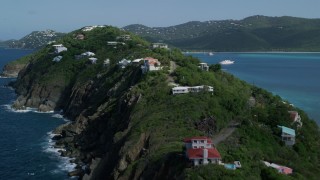 AX102_281 - 4.8K aerial stock footage of Hillside oceanfront homes in sapphire blue Caribbean waters, Magens Bay, St Thomas 