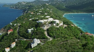 AX102_281E - 4.8K aerial stock footage of hillside oceanfront homes in sapphire blue Caribbean waters, Magens Bay, St Thomas