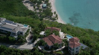 AX102_288 - 4.8K aerial stock footage of Hilltop mansions overlooking turquoise blue Caribbean waters, Magens Bay, St Thomas 