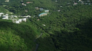 AX102_289 - 4.8K aerial stock footage of Condominiums on a hillside surrounded by trees, Northside, St Thomas 