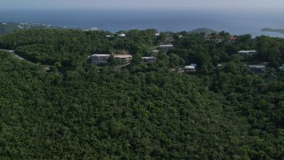 AX102_294 - 4.8K aerial stock footage of Hilltop Caribbean homes among trees, Northside, St Thomas