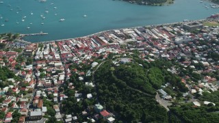 AX102_297 - 4.8K aerial stock footage of a Coastal town along turquoise blue Caribbean waters, Charlotte Amalie, St Thomas 