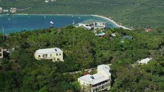 AX102_299 - 4.8K aerial stock footage of Hilltop mansions and Caribbean waters, Magens Bay, St Thomas 
