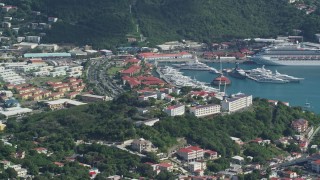 AX102_302 - 4.8K aerial stock footage of a Coastal town, cruise ship and yachts in Caribbean blue waters, Charlotte Amalie, St Thomas