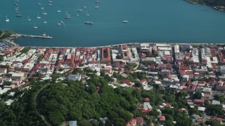 AX102_303 - 4.8K aerial stock footage of a Coastal town along sapphire blue Caribbean waters, Charlotte Amalie, St Thomas