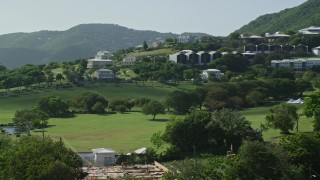 AX102_306 - 4.8K aerial stock footage of University of the Virgin Islands set among tree covered hillside, St Thomas