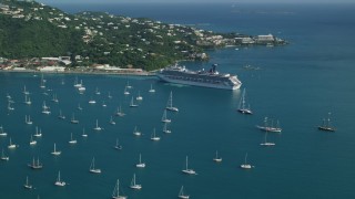 AX103_005 - 4.8K aerial stock footage of a Cruise ship and sailboats in turquoise blue Caribbean waters, Charlotte Amalie, St Thomas