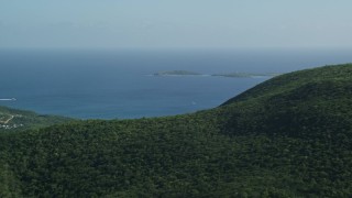 AX103_009E - 4.8K aerial stock footage of tree-covered hills above blue Caribbean waters, Southside, St Thomas