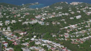 AX103_011 - 4.8K aerial stock footage of Coastal homes among trees along Caribbean blue waters, East End, St Thomas