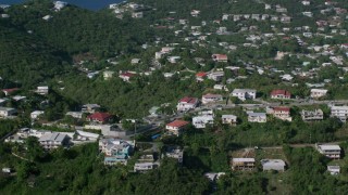 AX103_012 - 4.8K aerial stock footage of Homes among tree covered hills, East End, St Thomas