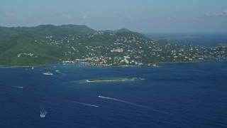 AX103_016 - 4.8K aerial stock footage of a Coastal town on a hillside and blue Caribbean waters, Cruz Bay, St John