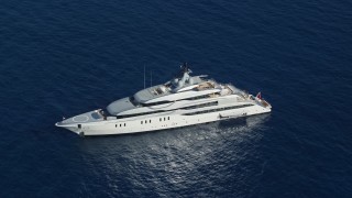 AX103_019 - 4.8K aerial stock footage of a Yacht in sapphire blue waters, Cruz Bay, St John