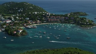 AX103_023E - 4.8K aerial stock footage of a resort overlooking the Caribbean blue harbor, Cruz Bay, St John