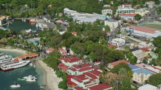 AX103_031 - 4.8K aerial stock footage of Waterfront Caribbean shops, Cruz Bay, St John