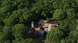 AX103_047 - 4.8K aerial stock footage of a Reef Bay Rum Factory Ruins nestled among trees, St John, US Virgin Islands