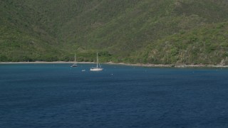 AX103_052 - 4.8K aerial stock footage of Sailboats in the Caribbean blue waters of Great Lameshur Bay, St John