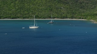 AX103_052E - 4.8K aerial stock footage of Sailboats in the Caribbean blue waters of Great Lameshur Bay, St John