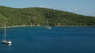 AX103_055 - 4.8K aerial stock footage of Sailboats its the blue waters of Great Lameshur Bay, St John