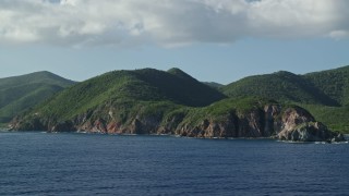 AX103_057 - 4.8K aerial stock footage of Coastal cliffs and jungle along sapphire blue Caribbean waters, Central, St John